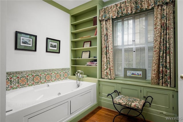 107 Oakland Pl Unit 1, Buffalo, NY 14222 - bathroom with a tub with jets and built in shelves