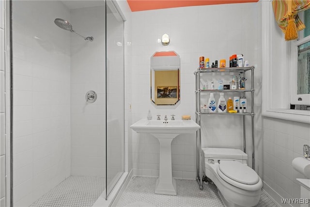 107 Oakland Pl Unit 1, Buffalo, NY 14222 - bathroom with tile walls, a stall shower, and tile patterned floors