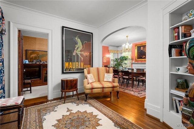 107 Oakland Pl Unit 1, Buffalo, NY 14222 - living area with crown molding, a chandelier, wood finished floors, and arched walkways
