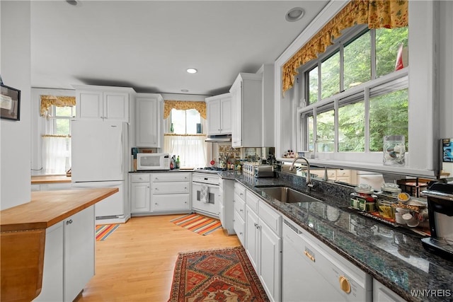 107 Oakland Pl Unit 1, Buffalo, NY 14222 - kitchen with white appliances, healthy amount of natural light, white cabinetry, under cabinet range hood, and recessed lighting
