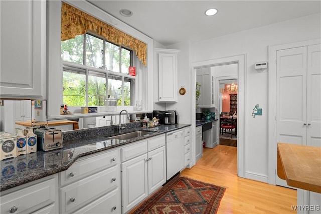 107 Oakland Pl Unit 1, Buffalo, NY 14222 - kitchen with dishwasher, white cabinets, light wood finished floors, dark stone countertops, and recessed lighting