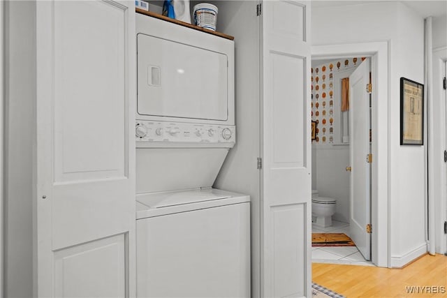 107 Oakland Pl Unit 1, Buffalo, NY 14222 - laundry area with stacked washer / drying machine and light wood-style floors