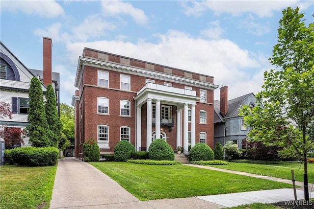 107 Oakland Pl Unit 1, Buffalo, NY 14222 - view of front facade with brick siding and a front yard
