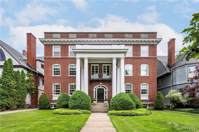 107 Oakland Pl Unit 1, Buffalo, NY 14222 - view of front of house with brick siding, a front yard, and a balcony