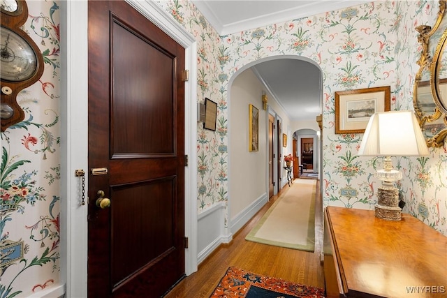 107 Oakland Pl Unit 1, Buffalo, NY 14222 - corridor featuring arched walkways, wood finished floors, wallpapered walls, and crown molding