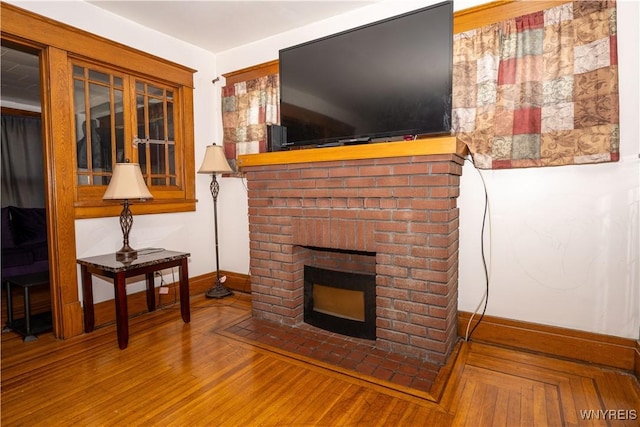 181 Ericson Ave, Buffalo, NY 14215 - living area with a brick fireplace and wood finished floors