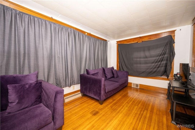 181 Ericson Ave, Buffalo, NY 14215 - living area featuring a baseboard heating unit and wood-type flooring
