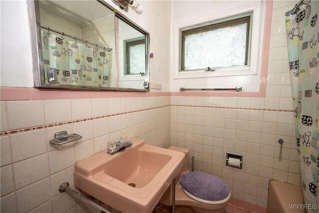 181 Ericson Ave, Buffalo, NY 14215 - bathroom with tile walls and a wainscoted wall