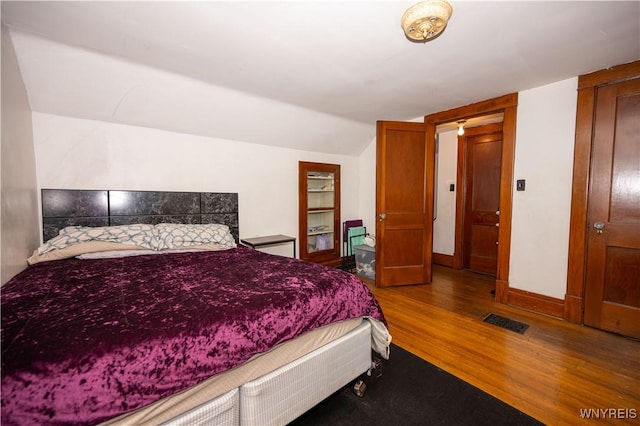 181 Ericson Ave, Buffalo, NY 14215 - bedroom featuring wood finished floors and vaulted ceiling