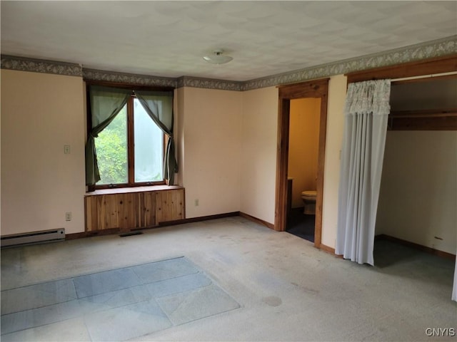 5465 Ridge Rd, Fleming, NY 13021 - unfurnished bedroom featuring a baseboard radiator, carpet, and connected bathroom