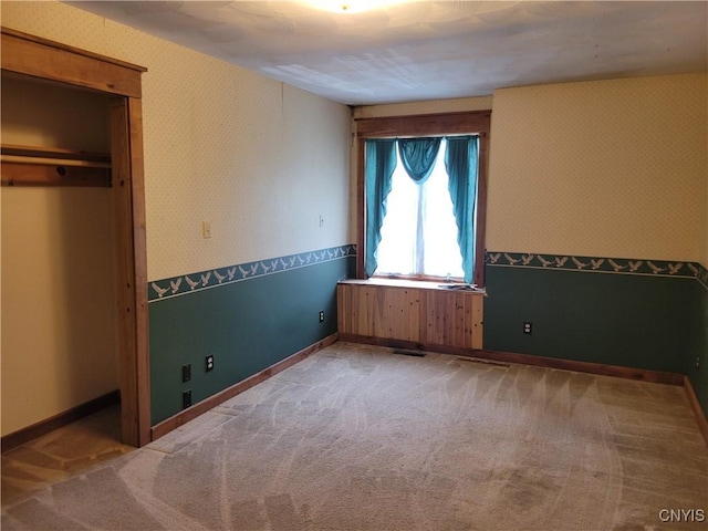 5465 Ridge Rd, Fleming, NY 13021 - unfurnished bedroom featuring wallpapered walls and light colored carpet