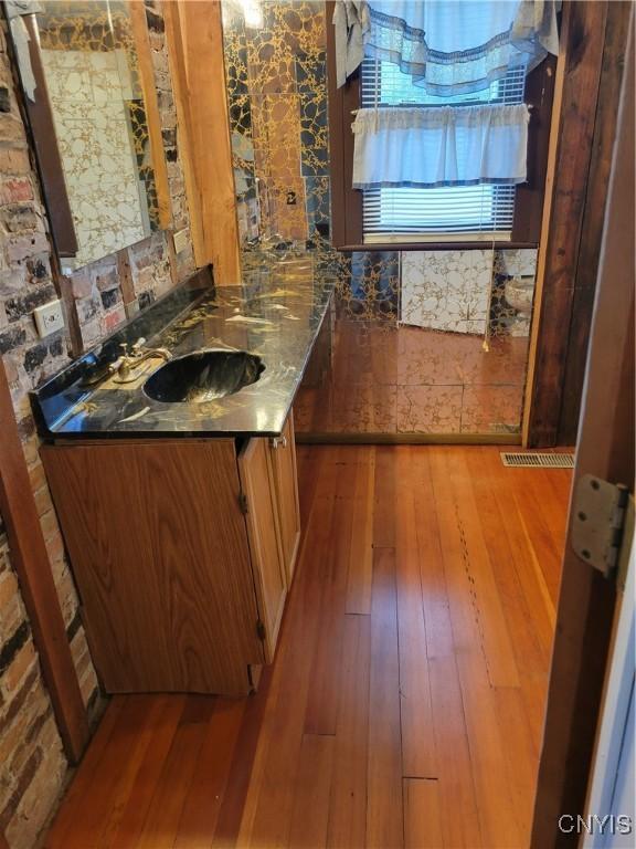 5465 Ridge Rd, Fleming, NY 13021 - kitchen with hardwood / wood-style floors and brown cabinets