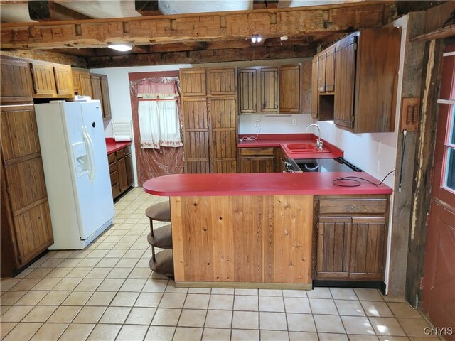 5465 Ridge Rd, Fleming, NY 13021 - kitchen with white fridge with ice dispenser, a peninsula, light tile patterned flooring, cooktop, and brown cabinetry