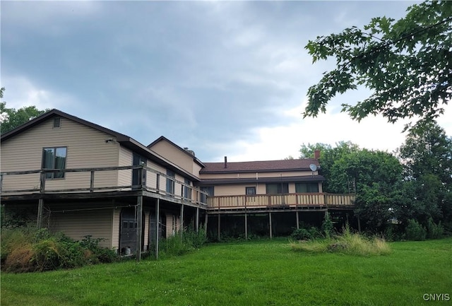 5465 Ridge Rd, Fleming, NY 13021 - rear view of house with a wooden deck, a lawn, and a chimney