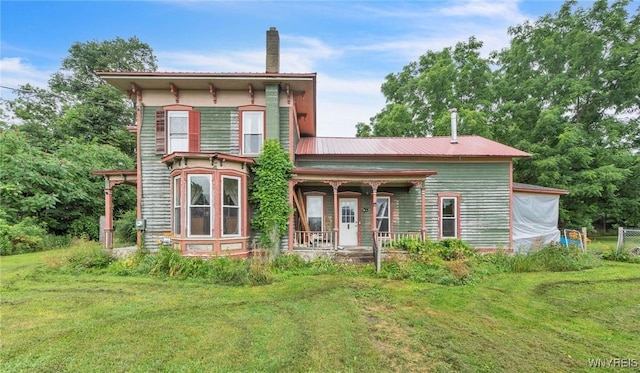 6192 Scudder Rd, Bath, NY 14879 - view of front of home with covered porch, a front lawn, a chimney, and a metal roof