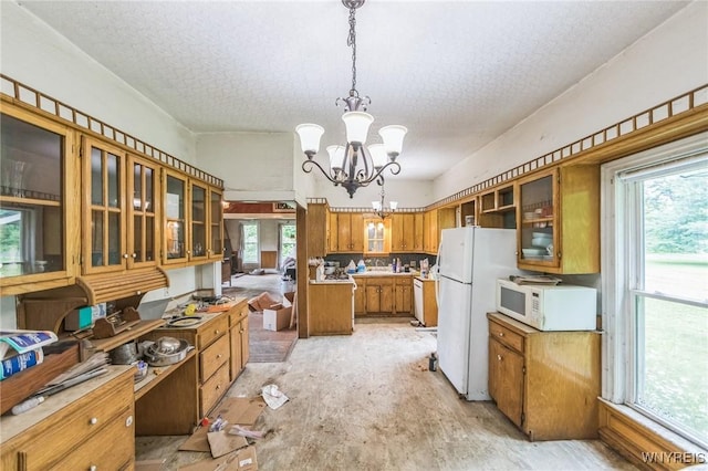 6192 Scudder Rd, Bath, NY 14879 - kitchen with white appliances, brown cabinets, a textured ceiling, a chandelier, and glass insert cabinets