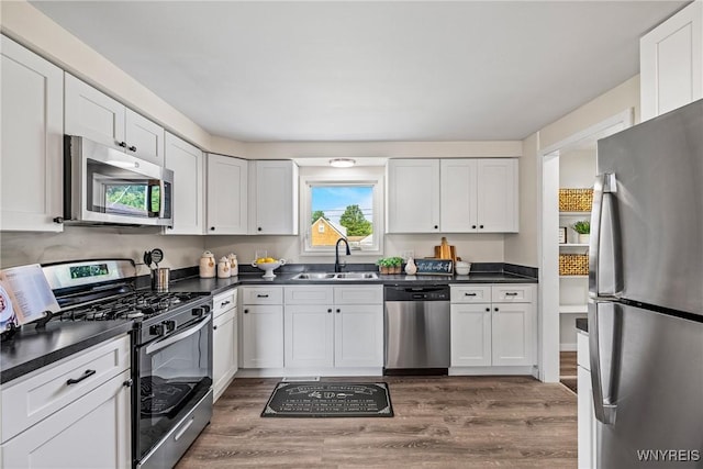 202 Waltercrest, West Seneca, NY 14224 - kitchen with appliances with stainless steel finishes, wood finished floors, dark countertops, and white cabinets