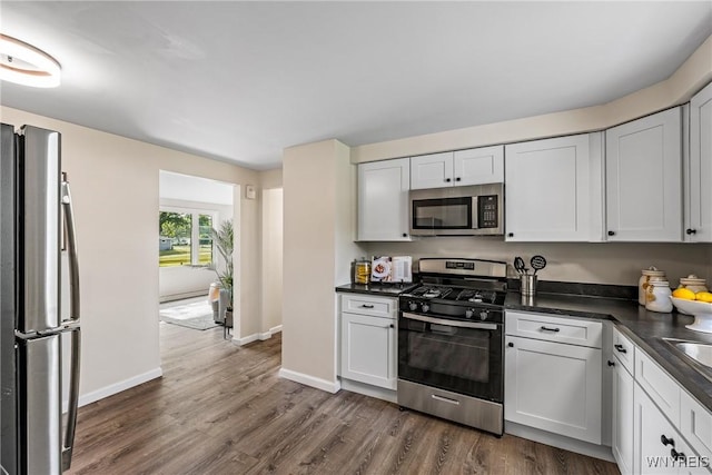 202 Waltercrest, West Seneca, NY 14224 - kitchen with stainless steel appliances, dark countertops, dark wood-style flooring, and white cabinets