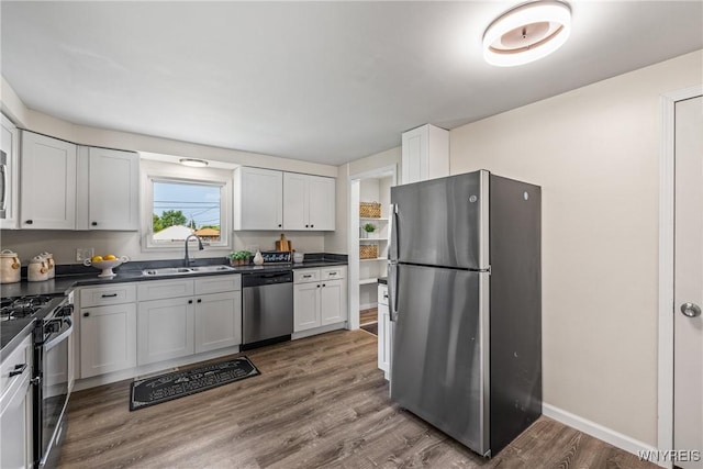 202 Waltercrest, West Seneca, NY 14224 - kitchen featuring appliances with stainless steel finishes, dark countertops, wood finished floors, and white cabinetry