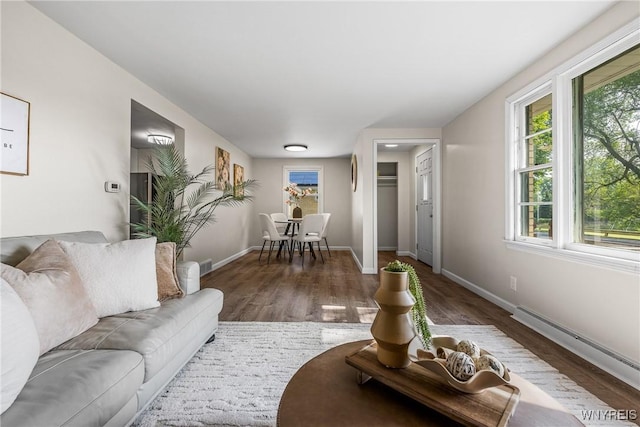 202 Waltercrest, West Seneca, NY 14224 - living room featuring healthy amount of natural light, wood finished floors, and a baseboard heating unit