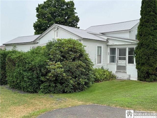 5469 E Lake Rd, Chautauqua, NY 14728 - view of home's exterior featuring entry steps, a lawn, and a metal roof
