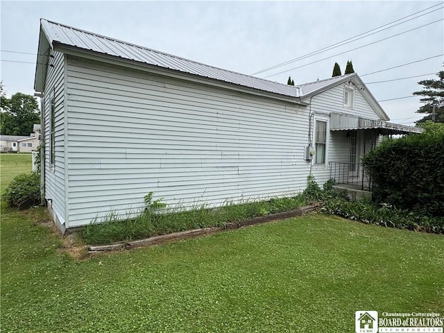 5469 E Lake Rd, Chautauqua, NY 14728 - view of property exterior featuring a yard and a metal roof
