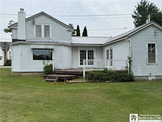 5469 E Lake Rd, Chautauqua, NY 14728 - back of house featuring a yard, a wooden deck, a chimney, and a metal roof