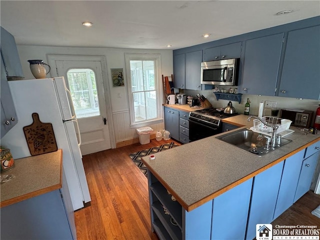 5469 E Lake Rd, Chautauqua, NY 14728 - kitchen featuring gas range oven, stainless steel microwave, a peninsula, and wood finished floors