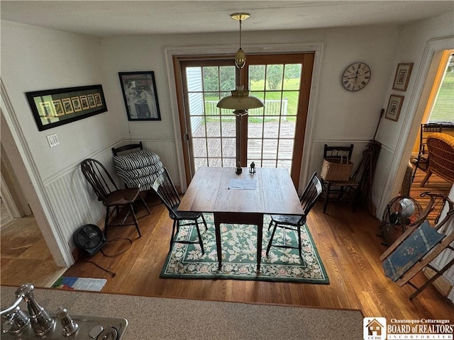 5469 E Lake Rd, Chautauqua, NY 14728 - dining space with wood finished floors and a wainscoted wall
