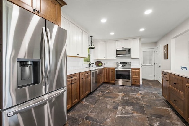 8281 E Main Rd, Leroy, NY 14482 - kitchen with stainless steel appliances, light countertops, white cabinetry, recessed lighting, and brown cabinets
