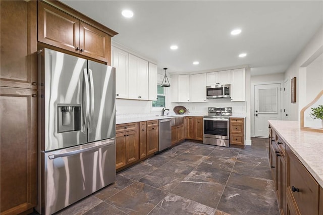 8281 E Main Rd, Leroy, NY 14482 - kitchen with stainless steel appliances, light countertops, white cabinets, recessed lighting, and brown cabinets