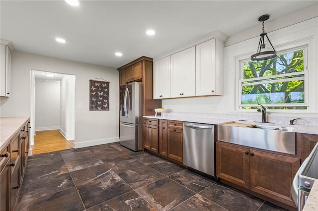 8281 E Main Rd, Leroy, NY 14482 - kitchen with appliances with stainless steel finishes, light countertops, recessed lighting, hanging light fixtures, and white cabinetry
