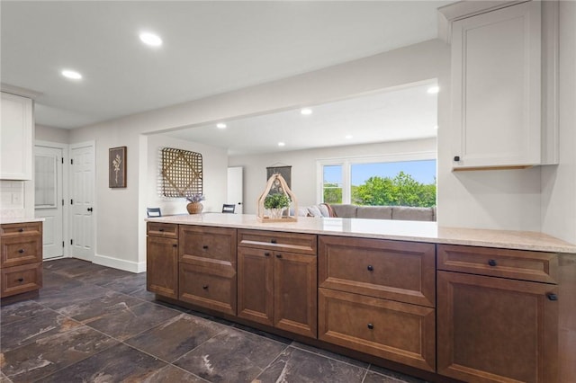 8281 E Main Rd, Leroy, NY 14482 - kitchen featuring white cabinetry, recessed lighting, dark stone finish flooring, and brown cabinets
