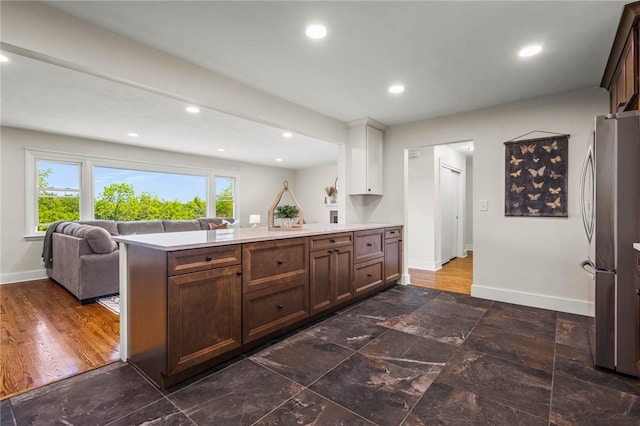 8281 E Main Rd, Leroy, NY 14482 - kitchen with freestanding refrigerator, open floor plan, light countertops, a peninsula, and recessed lighting