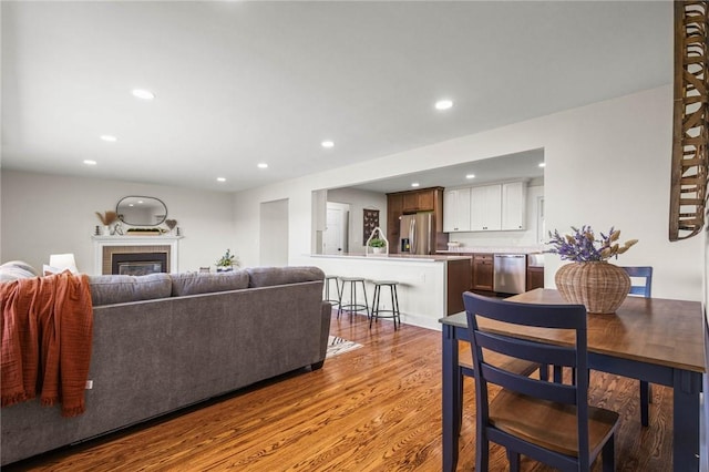 8281 E Main Rd, Leroy, NY 14482 - living area featuring light wood-style floors, recessed lighting, and a glass covered fireplace