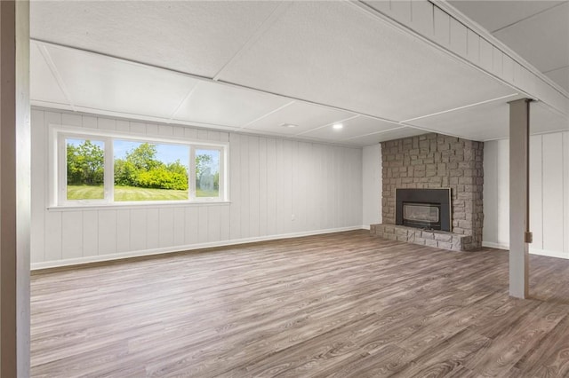 8281 E Main Rd, Leroy, NY 14482 - unfurnished living room with wood finished floors and a fireplace