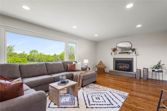 8281 E Main Rd, Leroy, NY 14482 - living room featuring wood finished floors, recessed lighting, and a brick fireplace