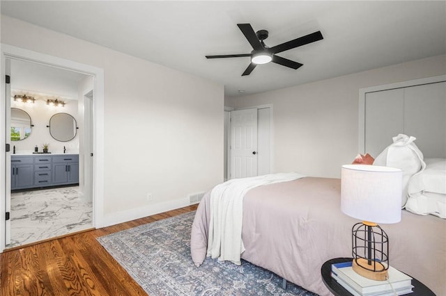 8281 E Main Rd, Leroy, NY 14482 - bedroom featuring wood finished floors, connected bathroom, two closets, and ceiling fan