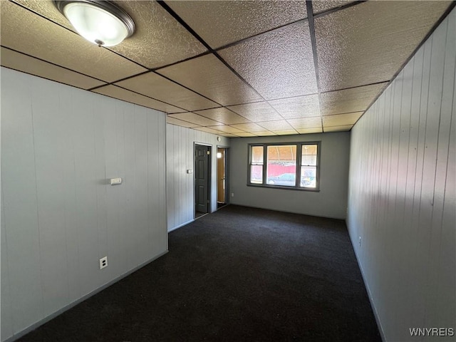360 Longnecker St, Buffalo, NY 14206 - unfurnished room with dark colored carpet, a paneled ceiling, and wood walls