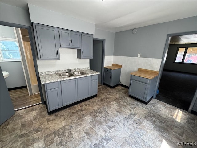 360 Longnecker St, Buffalo, NY 14206 - kitchen featuring gray cabinetry, light countertops, and stone finish floors
