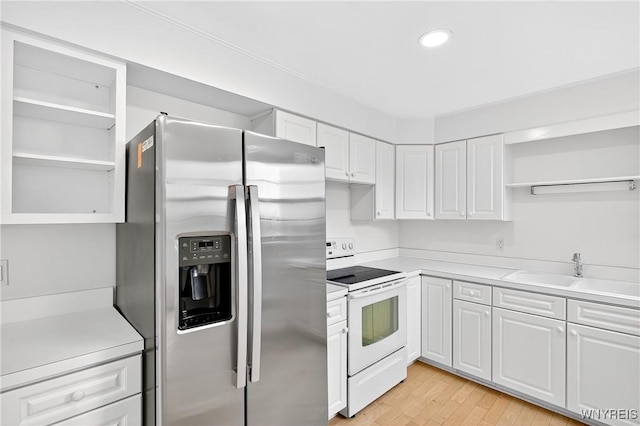 kitchen with stainless steel refrigerator with ice dispenser, electric range, open shelves, white cabinetry, and light countertops