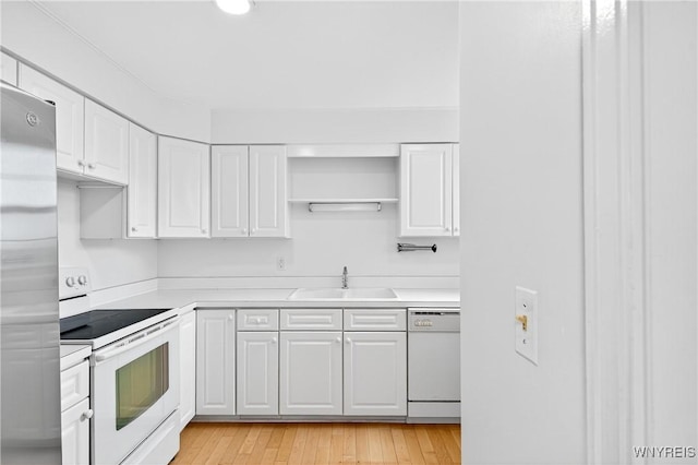 kitchen featuring white appliances, white cabinetry, light countertops, open shelves, and light wood-type flooring