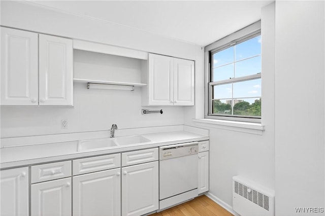 kitchen with white dishwasher, white cabinetry, open shelves, and light countertops