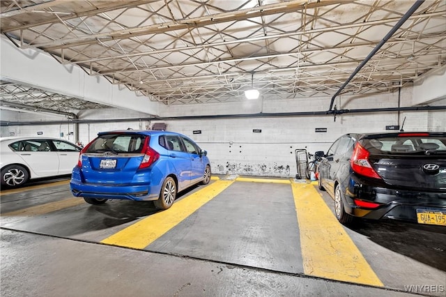 parking garage featuring concrete block wall