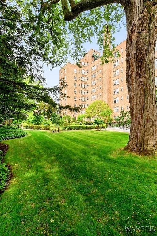 view of home's community featuring a lawn
