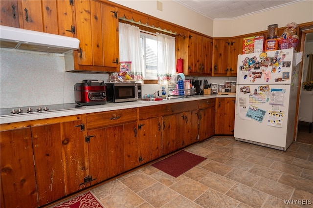 2363 Niagara St, Buffalo, NY 14207 - kitchen with freestanding refrigerator, stainless steel microwave, under cabinet range hood, and light countertops