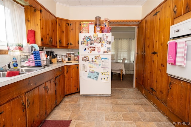 2363 Niagara St, Buffalo, NY 14207 - kitchen with white appliances, light countertops, brown cabinets, and crown molding