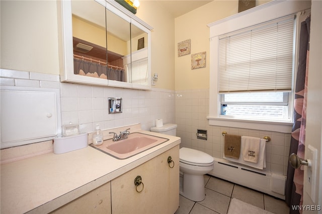 2363 Niagara St, Buffalo, NY 14207 - bathroom with a baseboard heating unit, tile walls, vanity, tile patterned flooring, and a shower with curtain