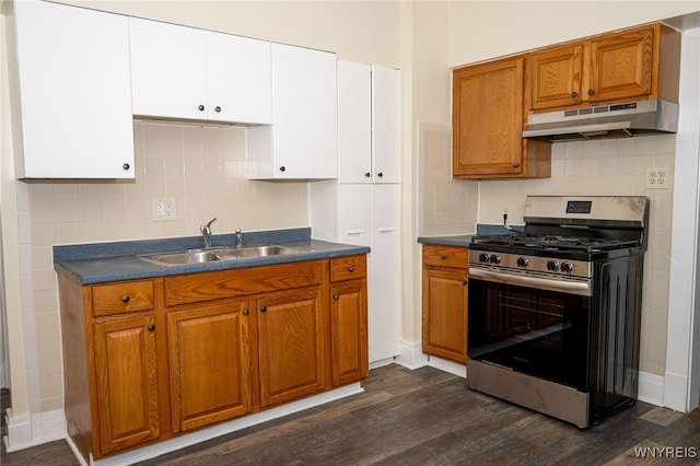 2363 Niagara St, Buffalo, NY 14207 - kitchen with stainless steel range with gas stovetop, under cabinet range hood, dark wood-style floors, dark countertops, and brown cabinetry