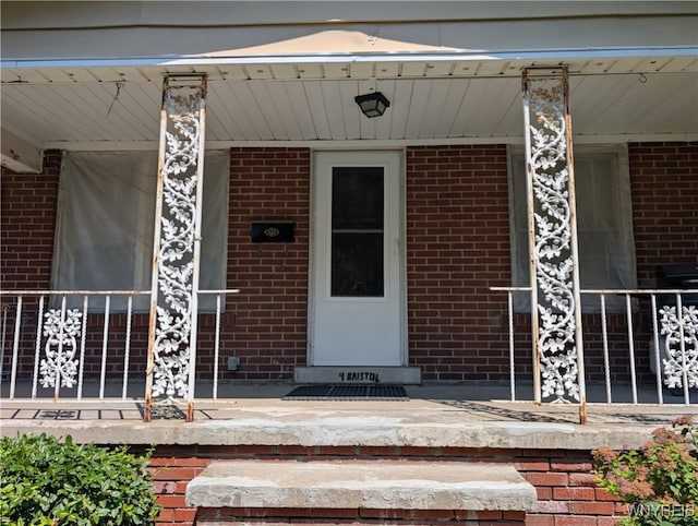 4 Bristol Ave, Lockport City, NY 14094 - view of exterior entry with covered porch and brick siding